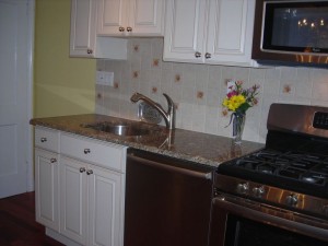 The new kitchen sports a built in dishwasher, gas/convection stove, granite and a tile backsplash.