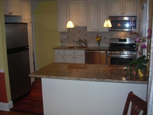 The refrigerator, stove and sink did not move location. The original dishwasher was a portable unit and was replaced with an undercounter unit. This made room for a pantry to the right of the refrigerator.