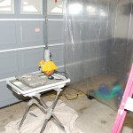 Clean-room Handyguy Paul set up an area in his garage to cut the tiles. He borrowd the saw. The plastic curtain kepts the mess contained.