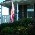 Solar spots lighting the flag on the porch
